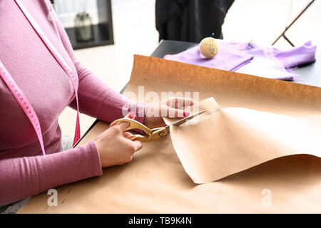 Female tailor working with sewing patterns in atelier Stock Photo