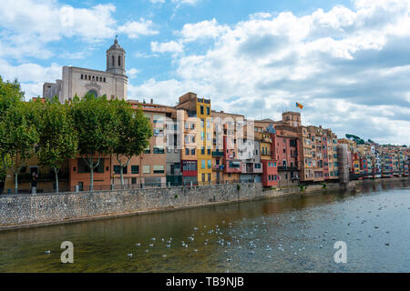 Girona, Spain - Sept 24 2018: View of Girona Cathedral, birds on the water and multi colored houses from bridge on the Onyar River, Girona, Spain Stock Photo