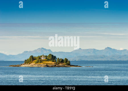 Guard Island and decomissioned lighthouse, originally built in 1903, at entrance to Tongass Narrows, near Ketchikan, Alaska. Stock Photo