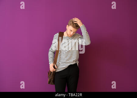 Handsome man with stylish briefcase on color background Stock Photo
