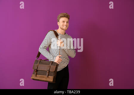Handsome man with stylish briefcase on color background Stock Photo