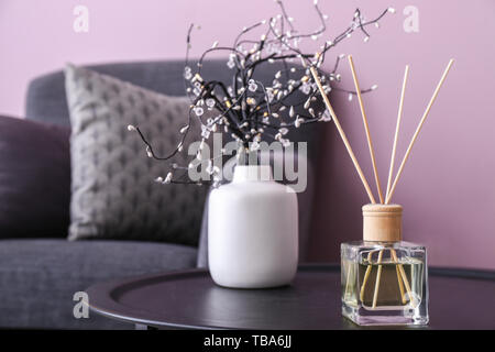Reed diffuser on table in room Stock Photo