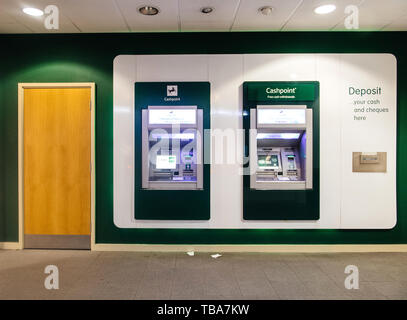 Oxford, United Kingdom - Mar 3, 2017: Lloyds Bank Free cash Withdrawal ATM machines near wooden door in central Oxford Branch Stock Photo