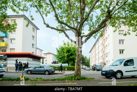 Strasbourg, France - May 3, 2018: Cite de l'Ill HLM Habitation a loyer modere rent-controlled housing French buildings with young group of arab boys Stock Photo