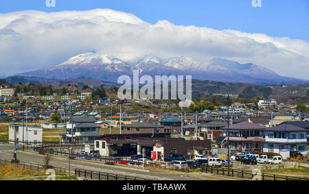 Fukushima, Japan - Apr 15, 2019. Cityscape with snow mountain in Fukushima, Japan. Fukushima is the place where the nuclear disaster occurred in 2011. Stock Photo