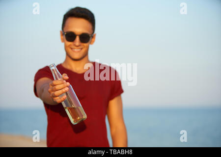 Man Drinking from Thermos on Beach - Stock Photo - Masterfile -  Rights-Managed, Artist: Masterfile, Code: 700-00606349