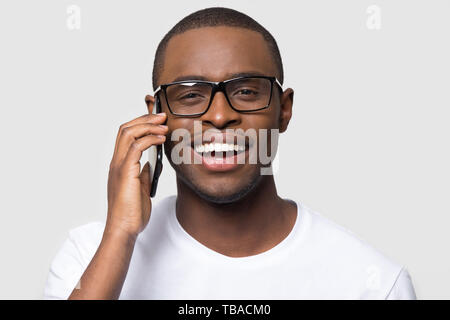 Happy african man talking using smartphone looking at camera Stock Photo