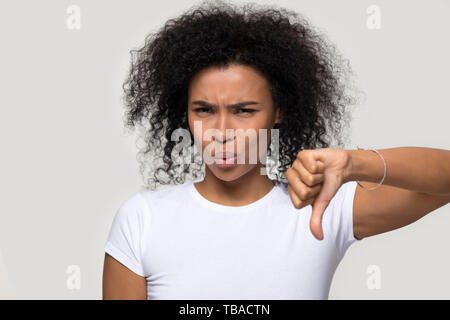 Unsatisfied african woman showing thumb down disapproval gesture Stock Photo