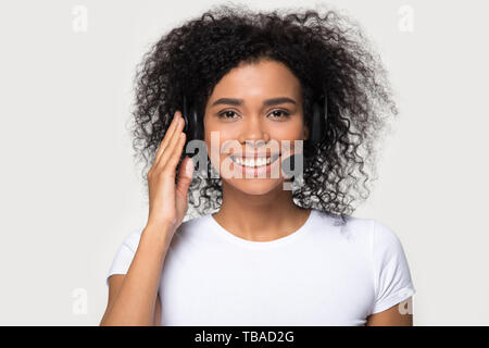 Mixed race female wearing headset smiling looking at camera Stock Photo