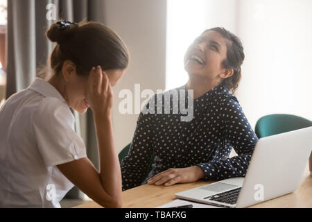 Smiling women have fun laughing at break at workplace Stock Photo