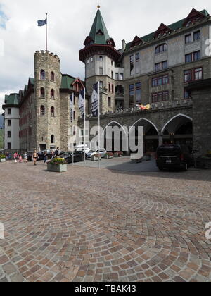 ST. MORITZ, SWITZERLAND on AUGUST 2018: Badrutt's palace hotel building in european city center with cloudy sky in warm sunny summer day - vertical. Stock Photo