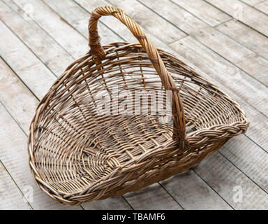 Empty wicker basket on a wooden background Stock Photo