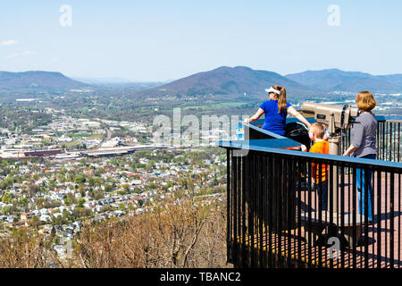 Roanoke, USA - April 18, 2018: City in Virginia during spring with people family during sunny day looking at view from Mill Mountain Park Stock Photo