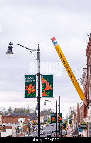 Wytheville, USA - April 19, 2018: Small town village sign for office supply in southern Virginia with banner and largest big pencil exterior Stock Photo