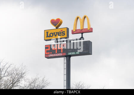 Meadowview, USA - April 19, 2018: Road street during day with closeup of Love's gas station light screen with price and McDonald's fast food restauran Stock Photo