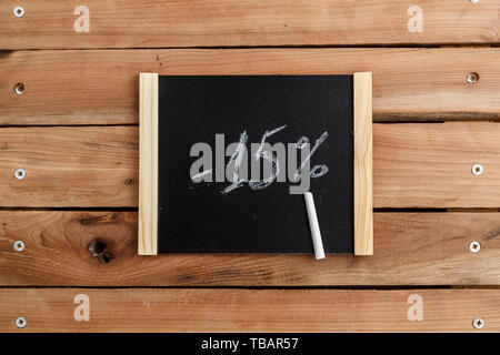 chalk Board with the inscription -15 percent on a wooden background. the view from the top Stock Photo