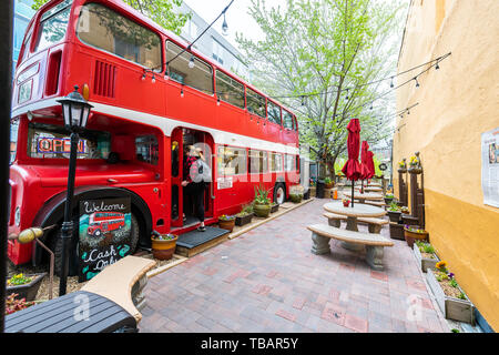 Asheville, USA - April 19, 2018: People boarding double decker d's bus cafe restaurant outside serving coffee drinks and desserts in North Carolina ci