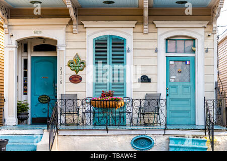 New Orleans, USA - April 22, 2018: Old Dauphine street district in Louisiana famous town with blue painted house wall shutters colorful entrance build Stock Photo