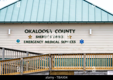 Fort Walton Beach, USA - April 24, 2018: Okaloosa Island county Sheriff's Office emergency medical services building with sign by beach by ramp in Flo Stock Photo