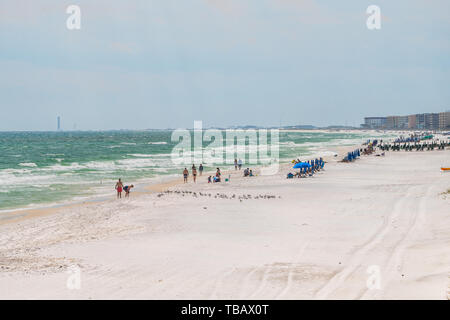 Fort Walton Beach, USA - April 24, 2018: Okaloosa Island in Florida Panhandle, Gulf of Mexico on summer sunny day, coastline with buildings, people wa Stock Photo