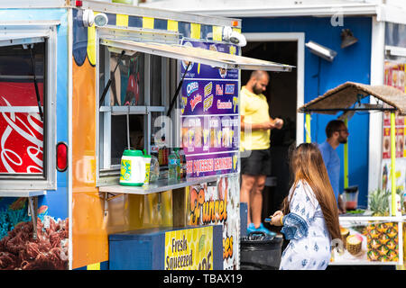 Destin, USA - April 24, 2018: Street stand vendor selling fresh squeezed lemonade, nachos and snacks at Harborwalk Village in Emerald Grande Coast in  Stock Photo