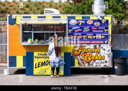 Destin, USA - April 24, 2018: Street stand vendor selling fresh squeezed lemonade, funnel cakes at Harborwalk Village in Emerald Grande Coast in Flori Stock Photo