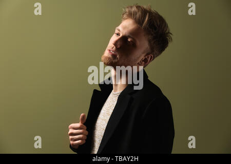 Fashionable young man on color background Stock Photo