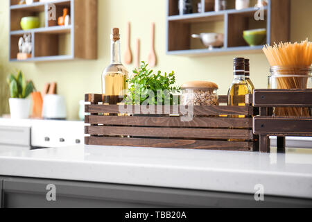 Wooden boxes with products on table in kitchen Stock Photo