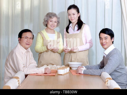 Happy Family Making Chinese Dumplings During Chinese New Year Stock Happy Family Making Chinese Dumplings During Chinese New Year Stock