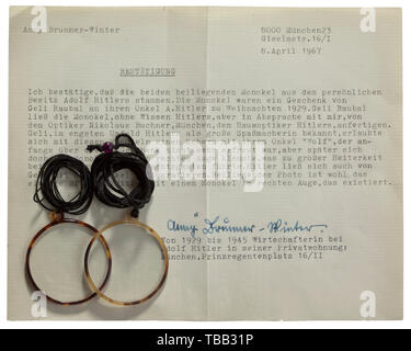 Anny Winter - two monocles of Adolf Hitler Gift from his niece 'Geli' Raubal - Christmas 1929. Both monocles with horn frame and on black silk cords, diameter each 40 mm. In gold embossed case of Nicolaus Buchner, court and university optician, Munich, Frauenplatz 10. With confirmation of Anny Winter-Brunner from 8 April 1967 (tr.): 'Geli Raubal had the monocles made without Hitler's - but with my - knowledge by Nicolaus Buchner, Hitler's favourite optician. Geli also took pictures of Hitler wearing a monocle.' In a paper packet bearing the name of the jeweller, with a conf, Editorial-Use-Only Stock Photo