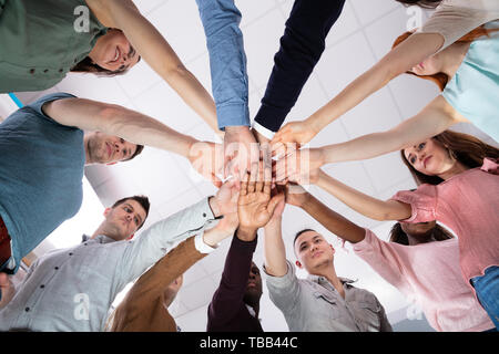Multi-ethnic Group Of People Stacking Hand Showing Unity Stock Photo