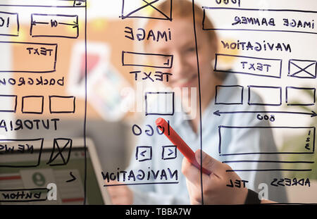 IT designers discussing project, view through transparent board Stock Photo