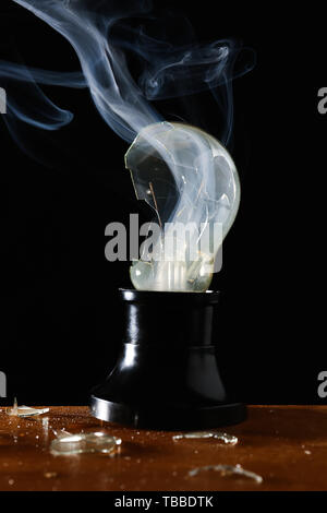 Crashed light bulb on dark background Stock Photo