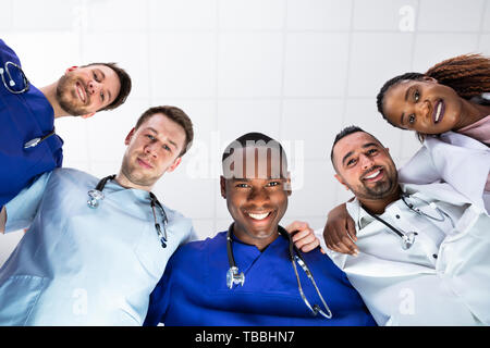 Low Angle View Of Smiling Diverse Medical Team Looking At Camera Stock Photo