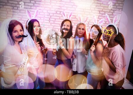Beautiful Women Enjoying Bachelorette Party With Drinks At Pub Stock Photo