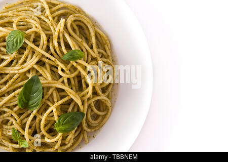 Spaghetti pasta with pesto sauce isolated on white background. Stock Photo