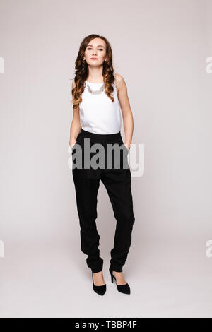 Successful female in smart outfit and glasses posing Stock Photo