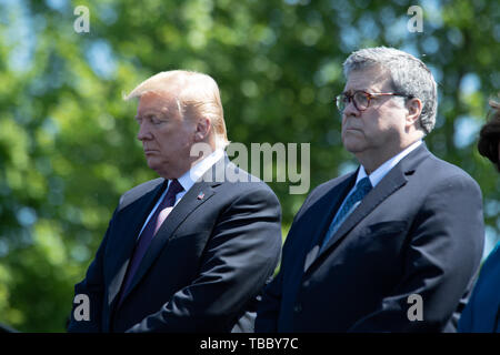 U.S President Donald Trump and Attorney General William Barr, right, stand for a moment of silence at the 38th Annual National Peace Officers Memorial Service on the West Lawn of the U.S. Capitol Building May 15, 2019 in Washington, DC. Stock Photo