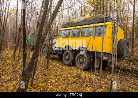 Kamczatka Peninsula, Russia- 30 September 2014: Russian off-road extreme expedition truck with passengers. Duct in the forest into deep Kamchatka. Stock Photo