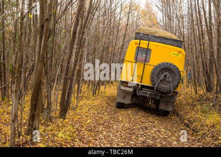 Kamczatka Peninsula, Russia- 30 September 2014: Russian off-road extreme expedition truck with passengers. Duct in the forest into deep Kamchatka. Stock Photo