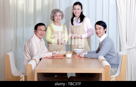 Happy Family Making Chinese Dumplings During Chinese New Year Stock Happy Family Making Chinese Dumplings During Chinese New Year Stock