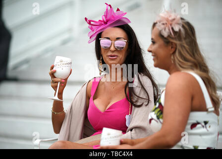 Racegoers enjoy the atmosphere during Ladies Day of the 2019 Invested Derby Festival at Epsom Racecourse, Epsom. Stock Photo