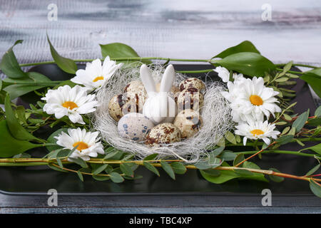 Plate with Easter decor on wooden table Stock Photo