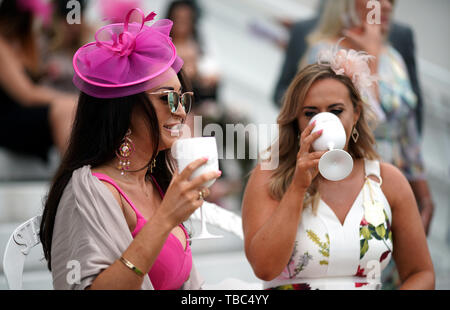 Racegoers enjoy the atmosphere during Ladies Day of the 2019 Invested Derby Festival at Epsom Racecourse, Epsom. Stock Photo