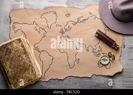Map with compass and spyglass on grey table Stock Photo