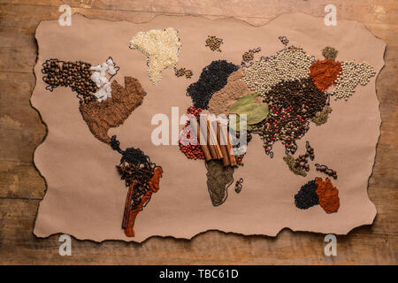World map made of different spices on wooden background Stock Photo