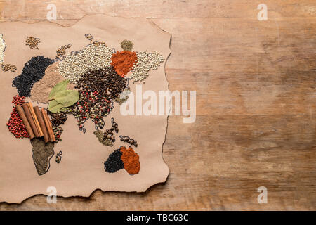World map made of different spices on wooden background Stock Photo