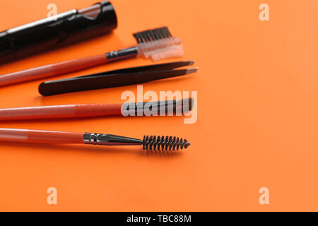 Set of tools for eyebrows correction on color background Stock Photo