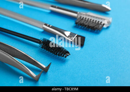 Set of tools for eyebrows correction on color background Stock Photo