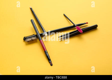 Set of tools for eyebrows correction on color background Stock Photo